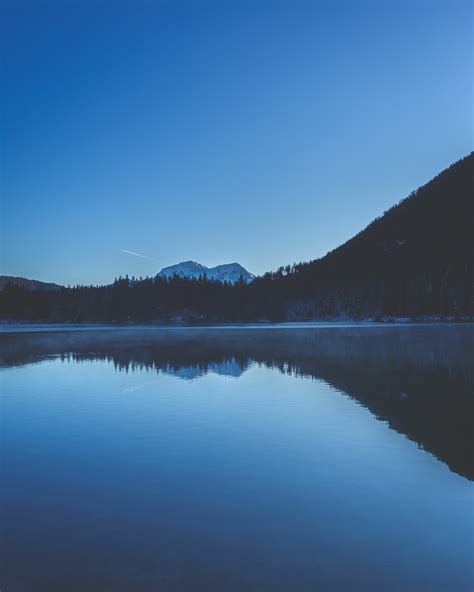Download 4000x5000 Lake Reflection Mountain Clear Sky Water Wallpapers