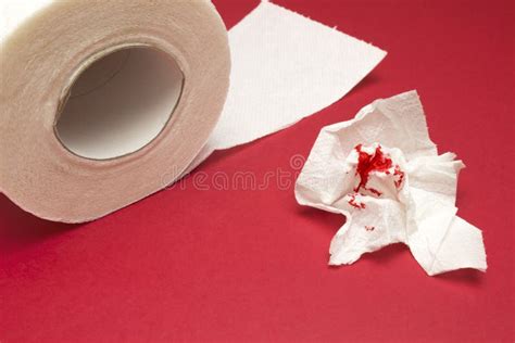 A Photo Of A Toilet Paper Roll And Two Used Bloody Toilet Paper Sheets
