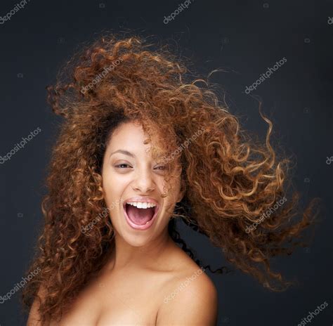 Portrait Of A Fun And Happy Young Woman Laughing With Hair Blowing