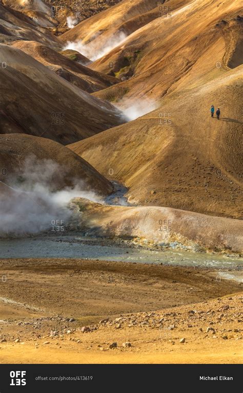 People Hiking In The Icelandic Geothermal Landscape In The Remote
