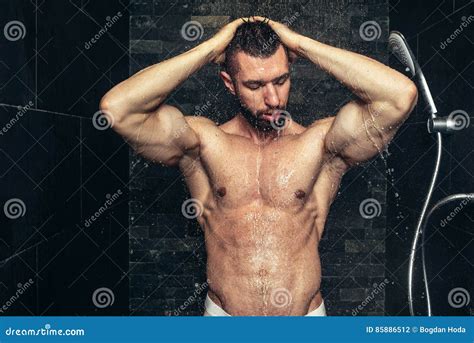handsome man taking a shower in the morning natural looking athlete showering royalty free