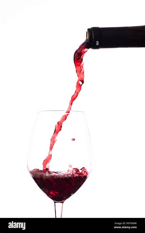 Red Wine Pouring In A Wine Glass On A White Background Stock Photo Alamy