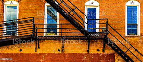Old Western Arched Windows Alley Fire Escape Stairs At An Old Faded