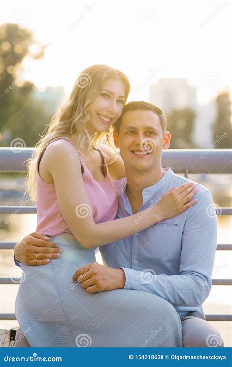 Beautiful Girl Sitting In A Guy`s Lap Hugging Him Stock Photo Image