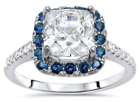 This timeless gemstone shape features large facets that maximize brilliance, and rounded corners that create a soft cushion cut diamonds have been sought after for centuries due to their enduring sophistication. 1.40ct Cushion Cut Moissanite, Diamond & Blue Sapphire Engagement Ring 14k White Gold / Front ...