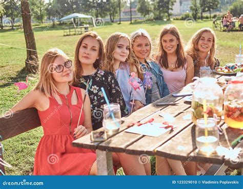 Group Of Happy Girlfriends Sitting At The Table Together Celebrating A