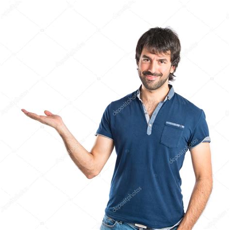 Man Holding Something Over White Background Stock Photo By