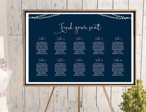 The Seating Chart For An Event Is Displayed On A Easel Next To A Potted