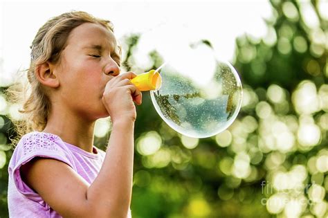 Girl Blowing Bubbles Photograph By Science Photo Library