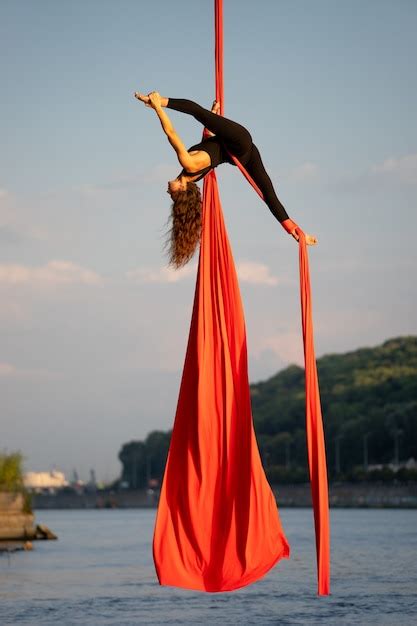 premium photo beautiful and flexible female circus artist dancing with aerial silk