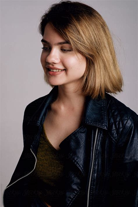 beautiful smiling teen girl in leather jacket by stocksy contributor
