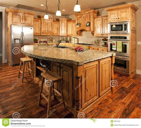 Custom kitchen cabinets help impart a distinctive appearance to kitchens, empowering them to narrate their story. Modern Home Kitchen Center Island Stock Images - Image ...