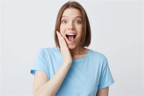 Free Photo Closeup Of Happy Excited Attractive Young Woman In Blue T Shirt With Opened Mouth