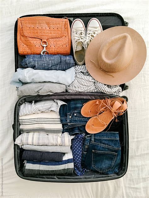 Suitcase With Packed Clothes And Accessories By Stocksy Contributor