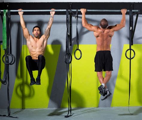 Premium Photo Crossfit Toes To Bar Men Pull Ups 2 Bars Workout