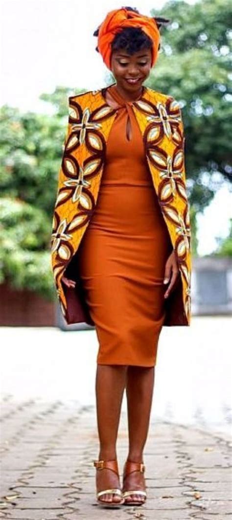 A Woman In An Orange Dress And Jacket