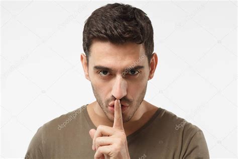 Close Up Shot Of Handsome Male With Shhh Gesture Asking For Silence Or