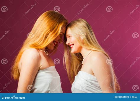 Two Women Standing Opposite Each Other Touching By Heads Stock Image