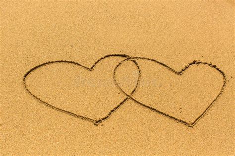 Two Hearts Drawn On The Sand Of A Sea Beach Stock Photo Image Of