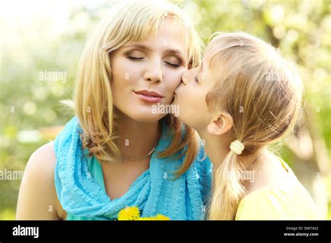 Hugging Happy Mother And Daughter For A Walk In The Park On A Light Green Background Daughter