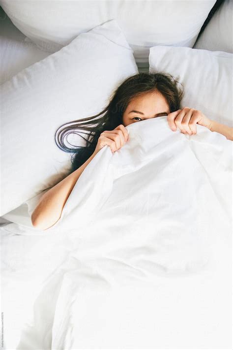 Young Woman Hiding Under Blanket In Bed Stocksy United Home Photo Shoots Photoshoot