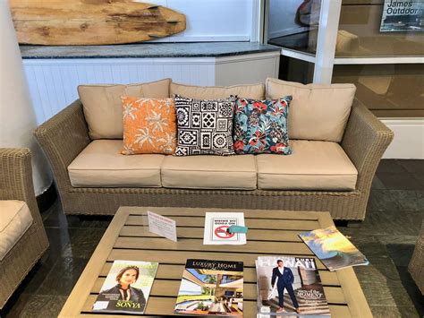 a living room filled with furniture and pillows on top of a coffee