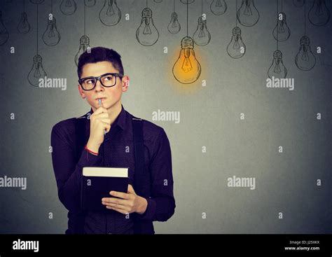 Handsome Thinking Man In Glasses Looking Up With Light Idea Bulb Above