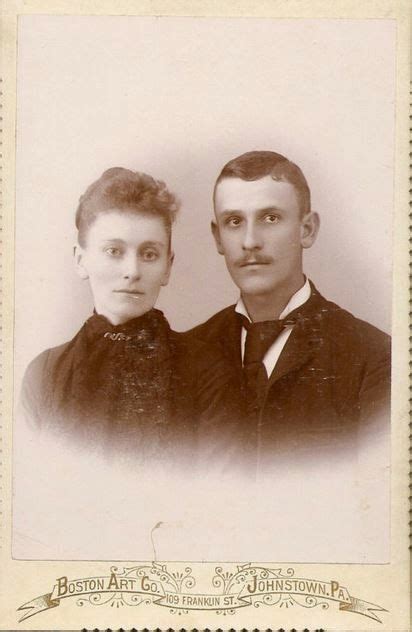 An Old Black And White Photo Of Two People