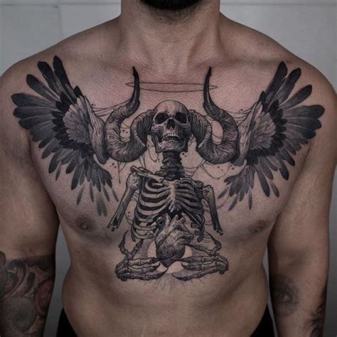 A Mans Chest With A Skeleton And Wings Tattoo On His Chest Is Shown