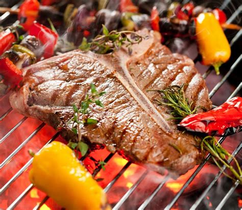 Beef T Bone Steaks On The Grill With Flames Stock Image Image Of
