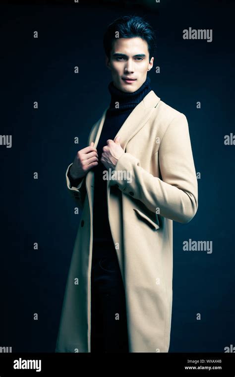 Cool Real Young Man In Coat On Black Background Posing Lifestyle