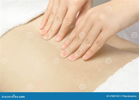 Masseur Applying Massage Techniques To Relax Back Muscles In Stock