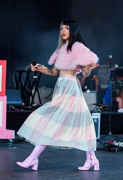 A Woman In A Pink And White Dress On Stage