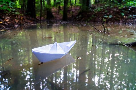 A Paper Boat Sailing In The Mountain Forest Lake Small Paper Boat