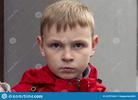The Serious Boy Serious Face Of A Boy In A Red Jacket Stock Image