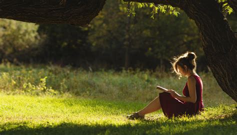 Girl Sitting Against Tree