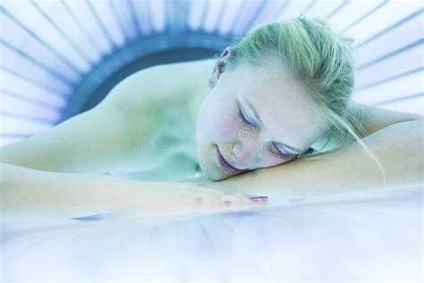 Pretty Young Woman Tanning Her Skin In A Modern Solarium Shall Stock