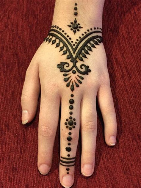 A Womans Hand With A Henna Tattoo On It