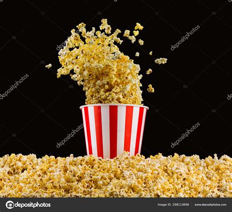 Flying Popcorn From Striped Bucket Isolated On Black Background — Stock
