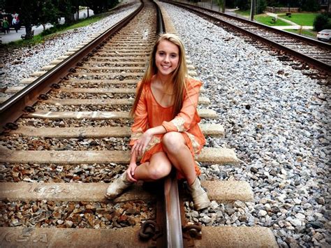 Girl Posos On Rail Road Track Wearing Dress And Boots Excellent Pose For Senior Picture For A