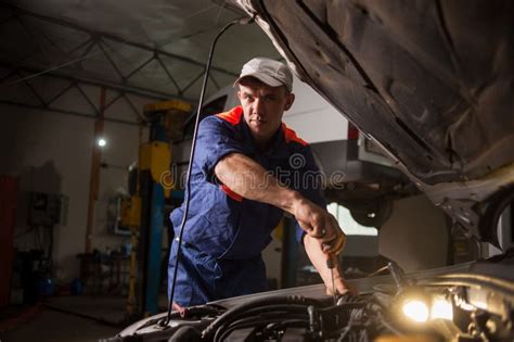 Car Mechanic Working In Auto Repair Service Repairing Car Using Stock