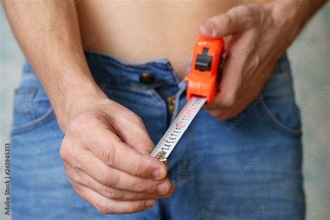 Man With Steel Tape Measure In His Hands Guy With Naked Torso In Jeans