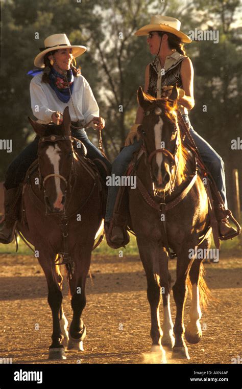 Two Women Dressed In Cowboy Clothes And Hats Riding Horses Western