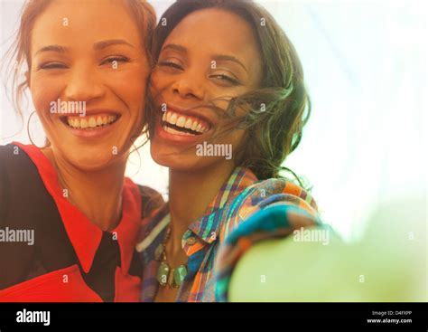 Women Smiling Together Outdoors Stock Photo Alamy