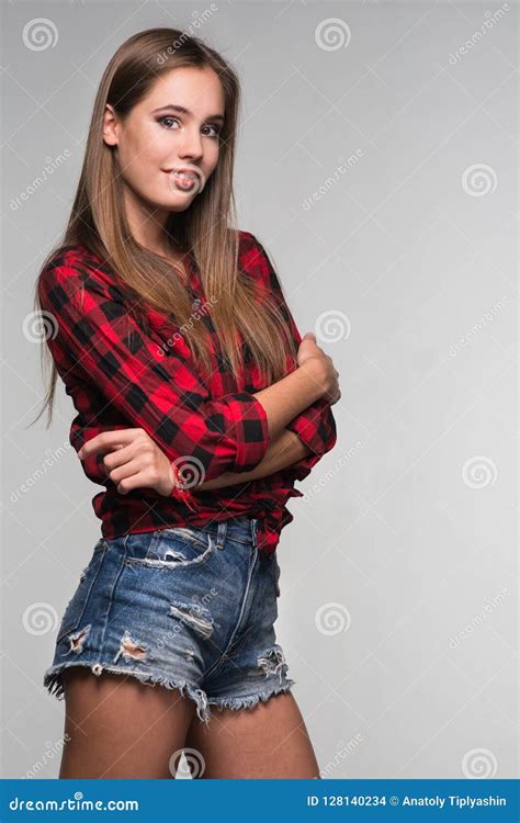 Young Beautiful Woman Teenager In A Red Checked Shirt And Torn D Stock