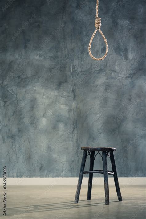The Old Chair With The Noose Hanging At Above With Concrete Wall At