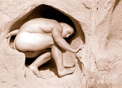 Nude Athletic Gay Man In Sand Cave On A Cliff By The Beach In A