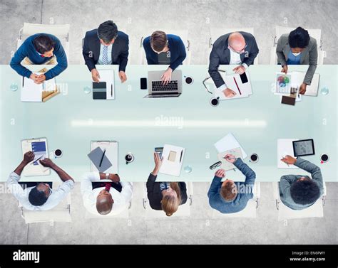 Business People Working Around A Conference Table Stock Photo Alamy