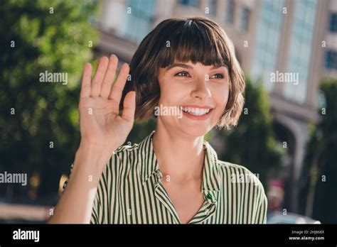 Photo Of Friendly Positive Cute Lady Raise Hand Wave Palm Beaming Smile