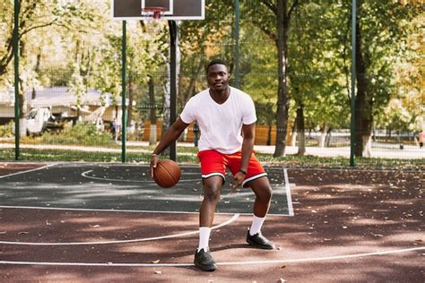 Premium Photo A Young African American Man Is Playing Basketball On